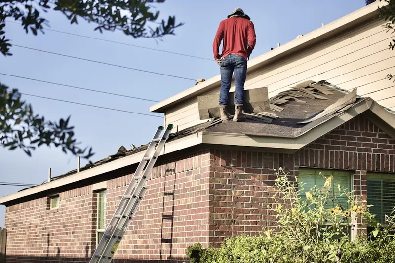 Professional roofer working on a residential roof in Lake Brant